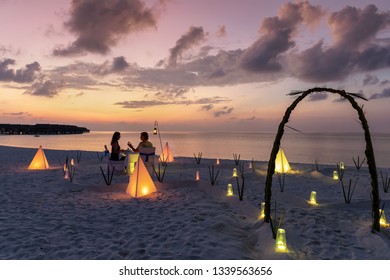 Private Event Dinner On A Tropical Beach During Sunset Time For A Honey Moon Couple In The Maldives Islands