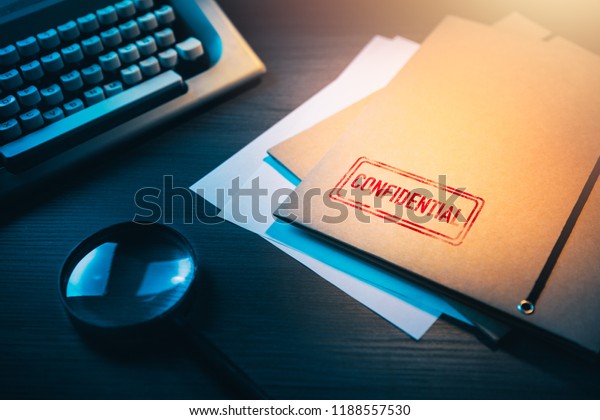 Private\
investigator desk with confidential\
envelopes