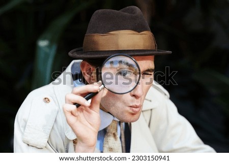 Private investigator, eye in magnifying glass and portrait of man for detective, searching and looking. Spy, investigation and male person with magnifier for secrets, information and mystery clue
