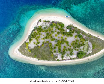 Private Island. Top View Of Small Isolated Tropical Island With White Sandy Beach And Blue Transparent Water And Coral Reefs