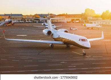 Private Jet Aircraft At Airport. Illuminated By The Sun At Sunset. Top And Side View. 