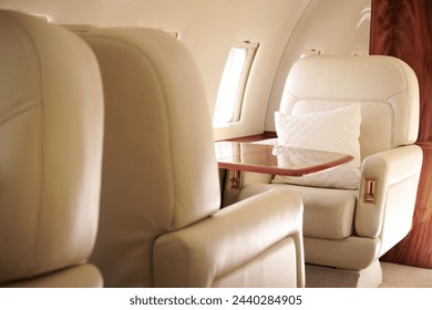 Private Jet Interior - Bombardier Challenger 604 - beige leather interior with wood and golden accents - Powered by Shutterstock