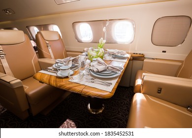 Private jet interior. Business jet flight. Luxury lifestyle. Business trip. Luxury travel. VIP flight. Private airplane. Executive aviation. Dinner in the sky. Airplane dining and tableware. - Powered by Shutterstock