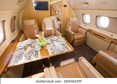 Private jet interior. Business jet flight. Luxury lifestyle. Business trip. Luxury travel. VIP flight. Private airplane. Executive aviation. Dinner in the sky. Airplane dining and tableware. - Powered by Shutterstock