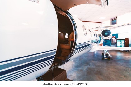 Private Jet With Open Door In A Hangar