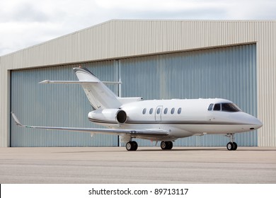 Private Jet Parked In Front Of Hangar