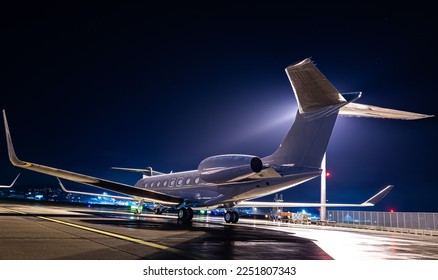 Private jet parked at night, making an elegant aviation background. Business jet is the way to travel for millionairs and successful people.