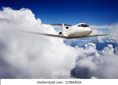 Private Jet Plane In The Blue Sky.
