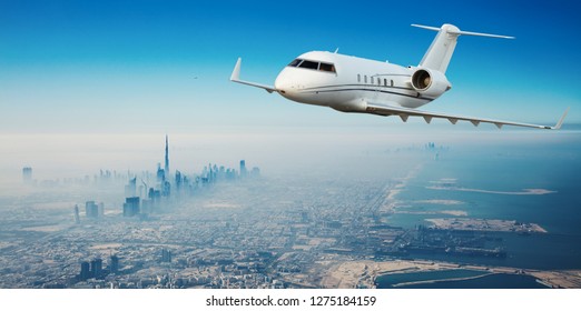 Private Jet Plane Flying Above Dubai City In Beautiful Sunset Light. Modern And Fastest Mode Of Transportation, Business Life.