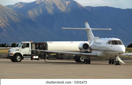 Private Jet Receiving Fuel From Tanker Truck