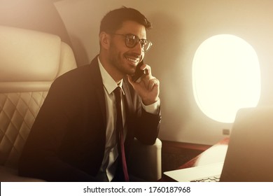 Private Jet. Rich Business Man Or Billionaire Flying First Class And Working On Plane, Talking On Phone