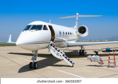 A Private Jet Sits Open On The Tarmac Anticipating The Arrival Of A Couple Of Pilots. 