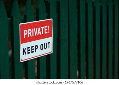 Private Keep Out Sign On A Green Fence