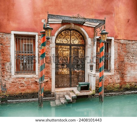 A private landing with traditional wooden posts leads to the canal entrance of a hotel in Venice.