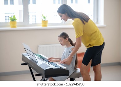 Private Lesson. Girl Having A Private Music Lesson And Looking Concentrated