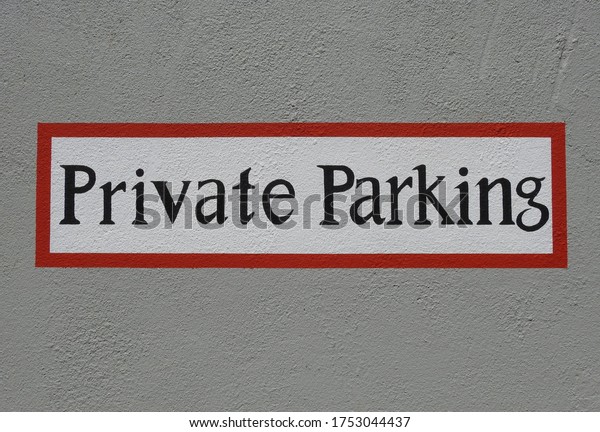 A \'Private Parking\'\
outdoors wall sign.
