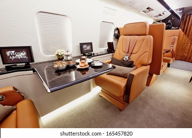 Private Plane Interior With Wooden Tables And Leather Seats