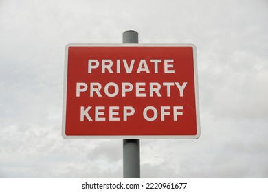 Private Property Keep Off Sign Post. Red Sign With Warning Message To Trespassers 