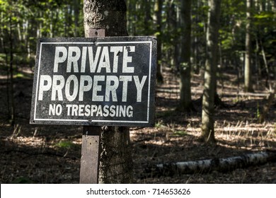 Private Property Keep Out Sign In Rural Forest Land Ownership Concept.