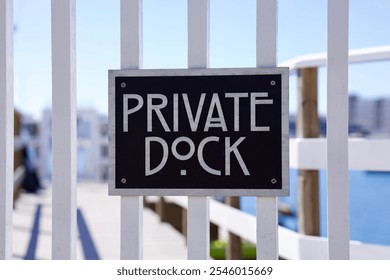 Private property sign on a white picket fence
