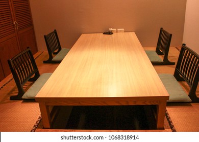 Private Room In Japanese Restaurant For 4 People. Restaurant Reservation. Wood Table And Chairs.