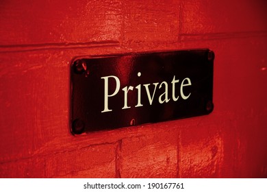 Private Sign On Red Door - Angled