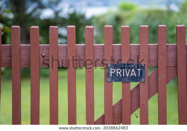 Private sign on the wooden fence in\
Austria, private ground - no trespassing, close\
up