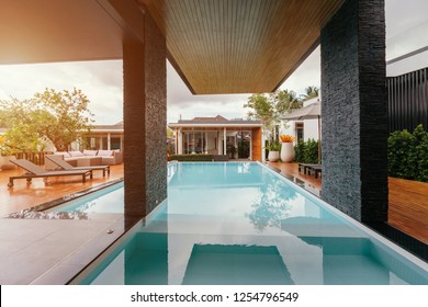 Private swimming pool near luxury villa. Sunny summer travel vacation