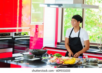 Private Thai Chef Cooking In A Modern Style Home Kitchen. Making Thai Food: Mixed Vegetables Oyster Sauce