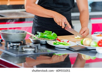 Private Thai Chef Cooking In A Modern Style Home Kitchen. Making Thai Food: Mixed Vegetables Oyster Sauce