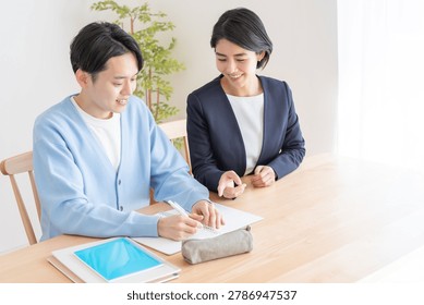 Private tutor teaching student preparing for entrance exams