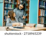 Private tutoring session inside library with tutor guiding student through reading study books showing personalized education support learning progress