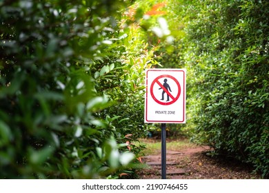 "Private zone" sign and symbol with human walking icon, placed in front of walk way and greenery tree plant background. Symbol object photo. - Shutterstock ID 2190746455