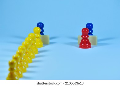 Privileges. An Individual Figure Is Served At One Counter While Many Others Wait Their Turn At Another Counter. Concept With Colored Pawns.