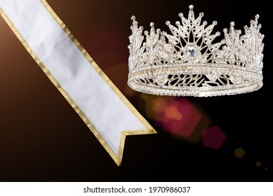 Prize Winning Award For Winner Of Miss Beauty Queen Pageant Contest Is Sash, Diamond Crown, Studio Lighting Abstract Dark Draping Textile Background