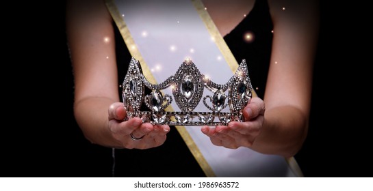 Prize Winning Award for Winner of Miss Beauty Queen Pageant Contest is Sash, Diamond Crown, studio lighting abstract dark draping textile background - Shutterstock ID 1986963572