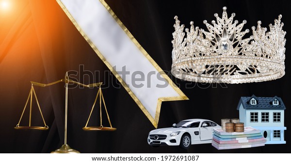 Prize\
Winning Award for Winner of Miss Beauty Queen Pageant Contest is\
Vehicle, Money, House, Sash, Diamond Crown and Fair justice. studio\
lighting abstract dark draping textile\
background
