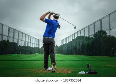 Pro golf is practicing at the golf driving range
A sports man plays golf and hit the ball on the golf course.
Golfer hits a fairway shot towards the club - Powered by Shutterstock