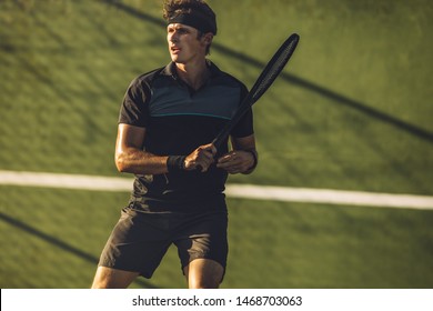 Pro Tennis Player Practicing Tennis On A Club Court. Young Male Tennis Player Playing On A Hard Court.