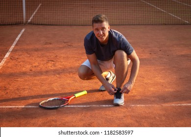 Pro tennis player tying sneakers on court for match - Powered by Shutterstock