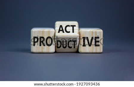Proactive and productive symbol. Turned cubes and changed the word 'productive' to 'proactive'. Beautiful grey background, copy space. Business, proactive and productive concept.