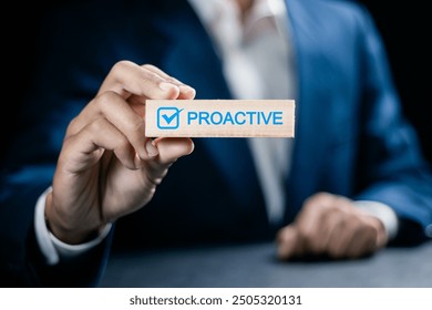 Proactive or reactive solution initiative concept. Businessman hold wooden block with  checkmark and text proactive.
