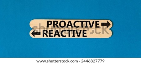 Proactive and reactive symbol. Concept word Proactive Reactive on beautiful wooden stick. Beautiful blue table blue background. Business proactive and reactive concept. Copy space.