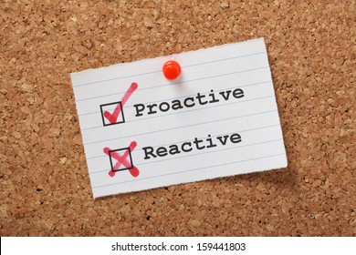 Proactive and Reactive tick boxes on a paper note pinned to a cork notice board.