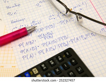 Probability exam, study set (hand writing notes, glasses, pencil and calculator - Shutterstock ID 252327457