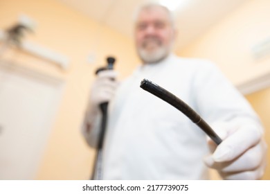 Probe for the study of the stomach close-up on the background of a blurred doctor.Gastroscopy, endoscopy. Apparatus for examining the cavity: fibrogastroduodenoscopy, examination of the stomach