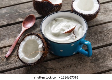 Probiotic food concept. Organic coconut yogurt in cup on rustic wooden table