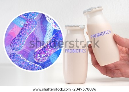 Probiotic products. Concept - yoghurt with probiotic content. Microbiome on purple background. Bifidobacteria for immunity. Probiotics in human hand. White bylots with anaerobic bacteria.