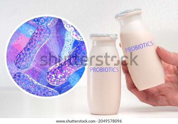 Probiotic\
products. Concept - yoghurt with probiotic content. Microbiome on\
purple background. Bifidobacteria for immunity. Probiotics in human\
hand. White bylots with anaerobic\
bacteria.