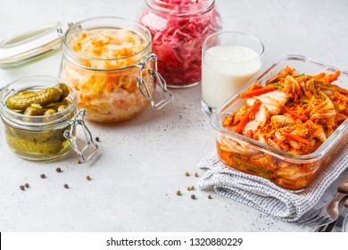 Probiotics Food Concept. Kimchi, Beet Sauerkraut, Sauerkraut, Kefir And Pickled Cucumbers In Glass Jars, White Background.